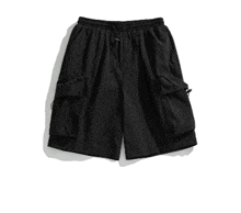 a pair of black shorts with pockets on a white surface