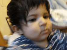 a close up of a baby 's face with a blurred background