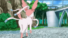 a pink and white pokemon is standing in front of a bridge in a park .