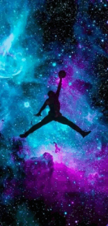 a silhouette of a man holding a basketball in the air against a galaxy background .