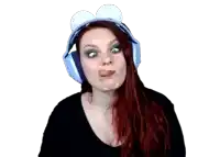 a woman with red hair is wearing a pair of blue headphones