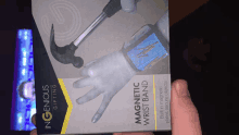 a person is holding a box for a magnetic wristband