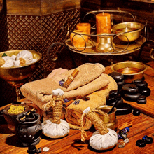 a wooden table with a stack of towels and candles