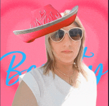 a woman wearing a red cowboy hat and sunglasses stands in front of a pink background with the letter b on it