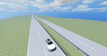 a white car is driving down a highway with a blue sky in the background