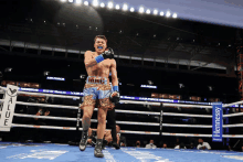 a boxer in a ring with a hennessy sign in the corner