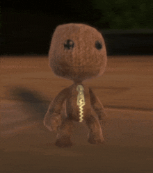 a stuffed animal with a zipper on its chest is standing on a wooden floor