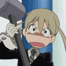 a girl in a suit and tie is holding a hammer and making a funny face