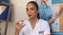 a woman in a white scrub has a name tag that says " clinica nacional "