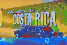 a car is parked in front of a sign for costa rica