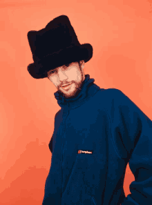 a man wearing a top hat and a blue berghaus fleece jacket