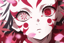 a close up of a person 's face with red eyes and a flower design on them