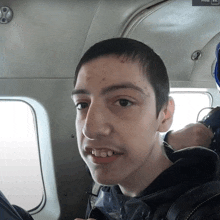 a young man sitting in a plane with a press esc button on the bottom right