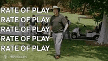 a man is walking on a golf course with a golf cart .