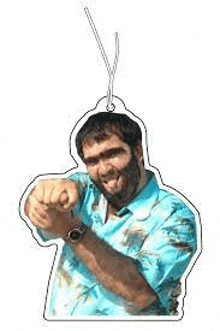 a man with a beard is pointing at the camera while wearing a blue shirt and a watch .