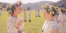 two women with flowers in their hair are standing in a field with the words " itools " written above them