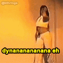 a woman is dancing in front of a yellow wall with the words dynanananana eh on the bottom