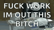 a panda mascot is sitting at a desk with the words `` fuck work im out this bitch '' written on it .