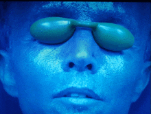 a close up of a person 's face wearing sunglasses