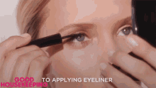 a woman is applying eyeliner with the words good housekeeping in the corner