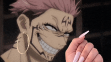 a close up of a person holding a pen in front of a cartoon character with long nails .