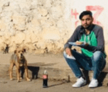 a man is sitting on the ground with a plate of food and a bottle of coca cola .