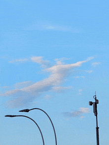 a street light is against a cloudy blue sky