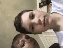 two young boys pose for a picture in front of a clock