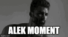 a black and white photo of a man with a beard and the words " alek moment " on the bottom