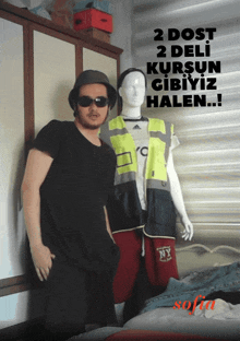 a man standing next to a mannequin with the words 2 dost 2 deli kurşun gibiyiz halen