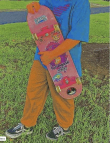 a person holding a pink skateboard that says grizzly house