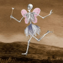 a skeleton dressed as a fairy with pink wings is holding a wand