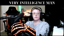 a man wearing a skeleton glove is sitting in front of a microphone with the words " very intelligence man " above him