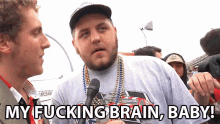 a man talking into a microphone with the words " my fucking brain baby " below him