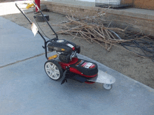 a red and black lawn mower with a sticker that says gt on it