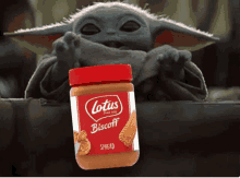 a jar of lotus biscoff peanut butter next to a baby