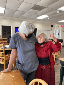 a woman wearing a scrub top that says ' compassion ' on it