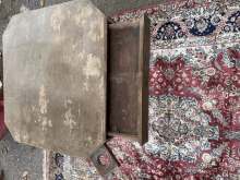 a wooden table with a drawer underneath it is sitting on a rug