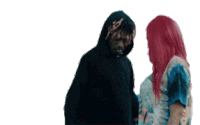 a man and a woman are standing next to each other and the woman has pink hair