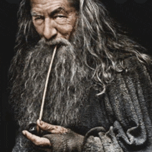 a man with a long beard smoking a pipe