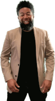 a man with a beard wearing a tan jacket and a black shirt