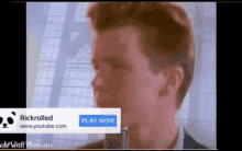 a man is singing into a microphone with an advertisement for rickrolled on the bottom