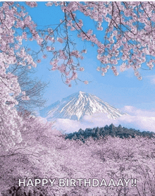 a birthday card with a mountain in the background and cherry blossom trees in the foreground