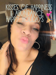 a woman blowing a kiss with the words kisses of happiness and abundance happy holidays behind her