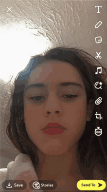 a screenshot of a girl 's face with a send to button at the bottom