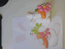 a drawing of a bunny with a carrot and a flower on it