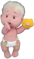 a crocheted baby in a diaper holds a pacifier