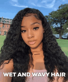 a woman with wet and wavy hair takes a selfie in a park