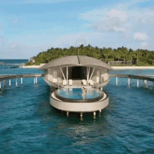 a woman in a bikini is standing in a swimming pool on a boat in the ocean .