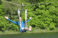 a man is flying through the air on a zip line